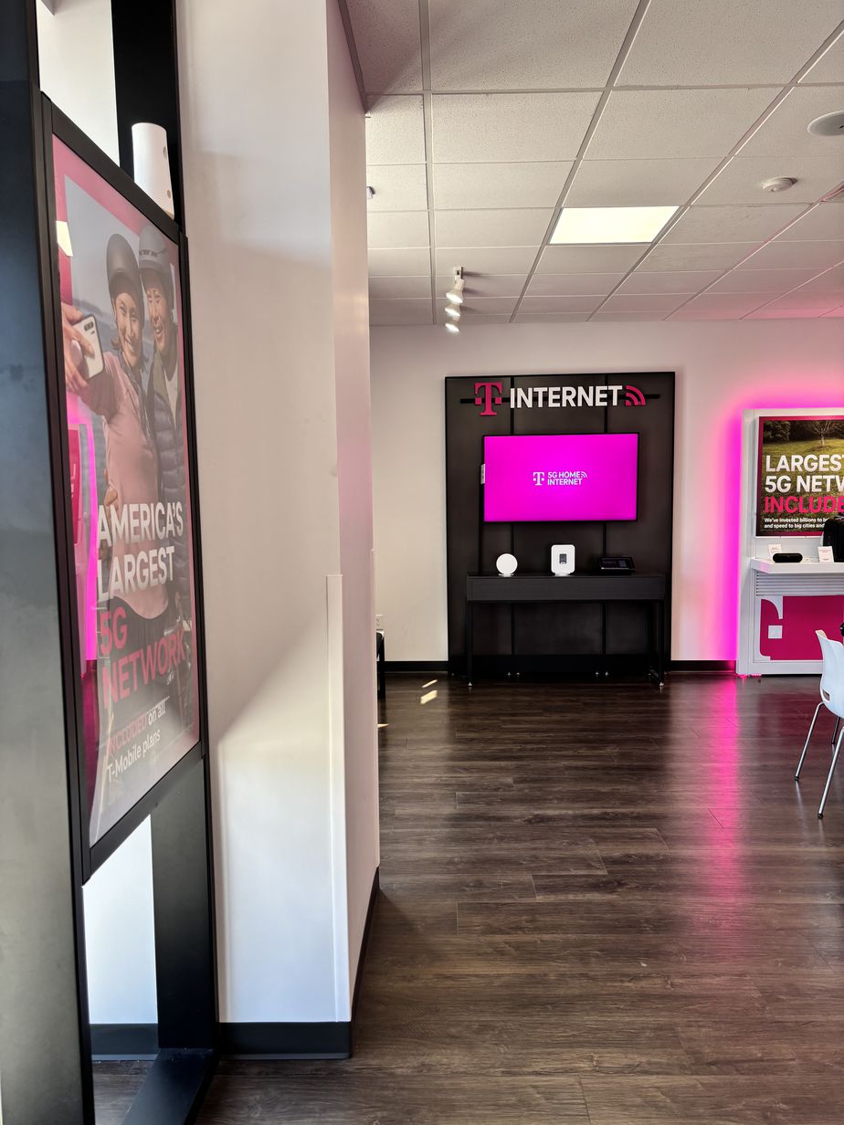 Interior photo of T-Mobile Store at Cooper & Simmons, Henderson, NC