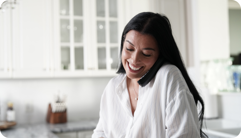 Woman making a call on a home phone